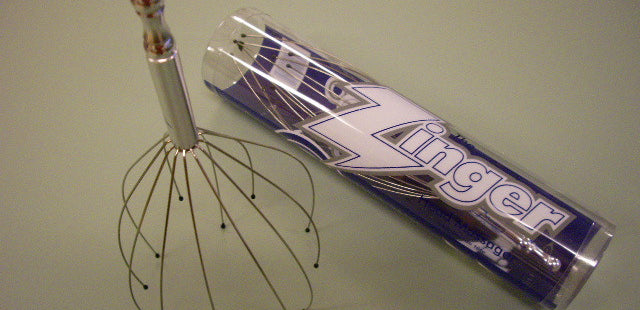 zingr head masager with soft resin-tipped stainless steel to stimulate nerve endings.