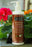 Bon Vital coconut massage lotion with pump, in front of flower box at massage therapy supply outlet store